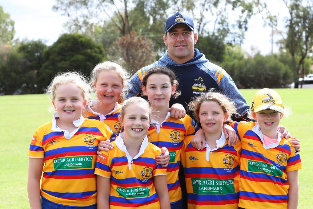 COUNTRY BOY: Brumbies veteran Josh Mann-Rea with girls from Hay Cutters' Whipper Snippers.