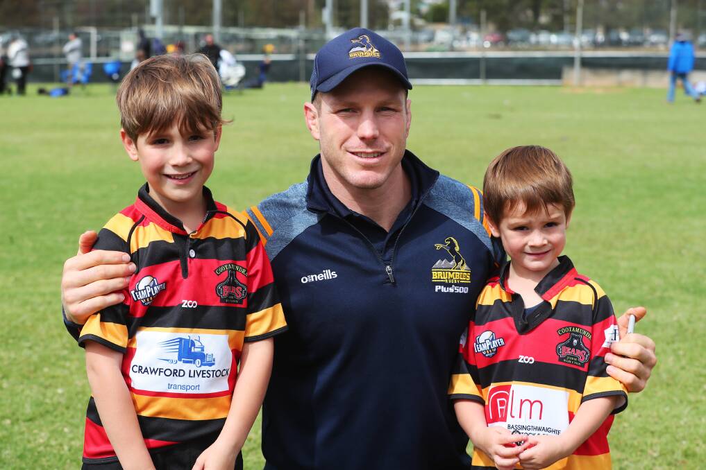 HEADLINE ACT: Brumbies and Wallabies star David Pocock spends time with Hamish Clark, 7 and Digby Clark, 5.