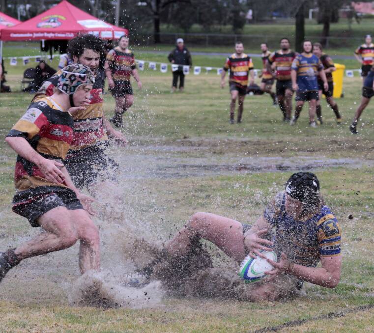The Tri Colours adapted best to the conditions for a 60-0 win. Photo by Kelly Manwaring.