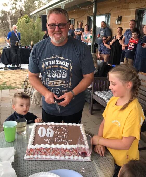 GOOD MAN GLEN: Popular local gentleman Glen McAtear prepares to cut his 60th birthday cake with his grandchildren ready to sing Happy Birthday.