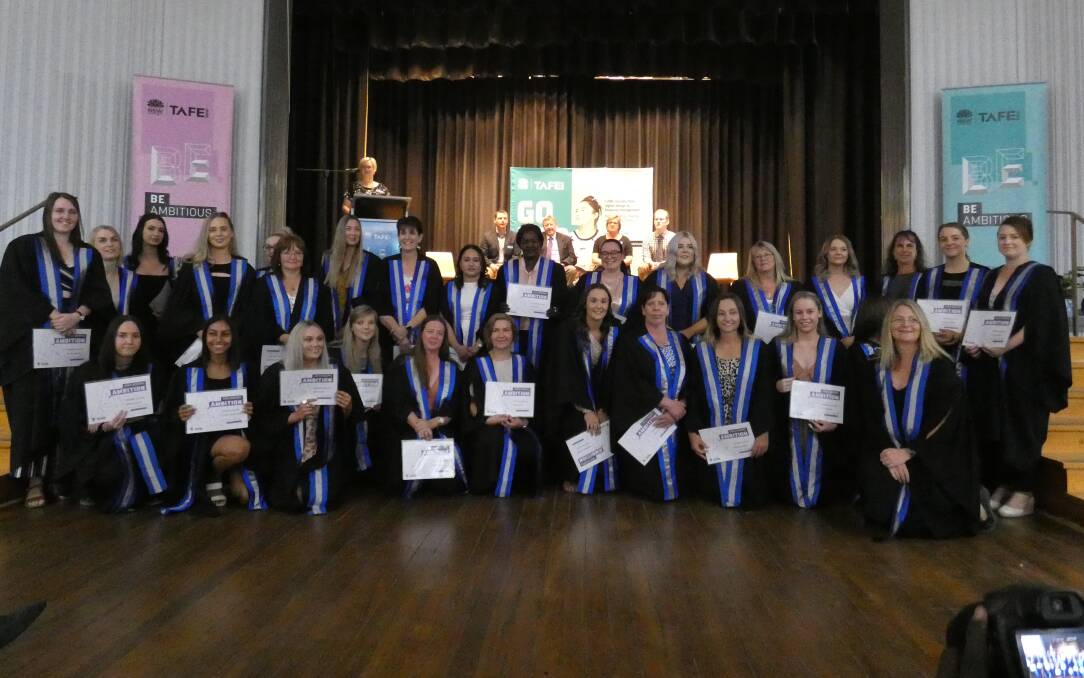 Important moment: Diplomas of Nursing were presented to 32 graduates by a regional TAFE manager Grant Ingram at a ceremony last Friday.