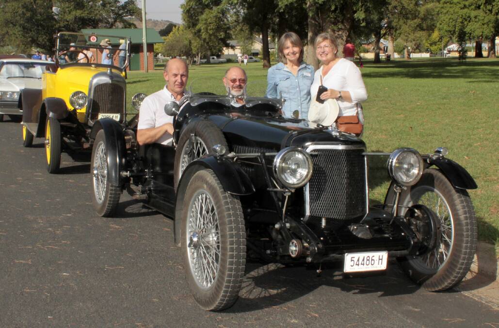 Greg Snape of Yass in the drivers seat of an Armstrong Siddeley TT Sports 1936 with Holger Krueger of Germany, standing are Glenda Snape and Baerbel Dahms.