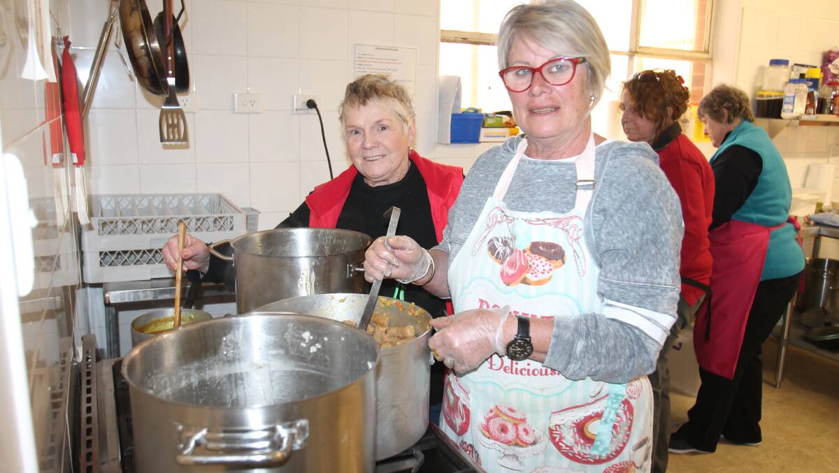 Kate Lonergan (left) and Virginia Birch prepare Wednesday night's meal at the community kitchen