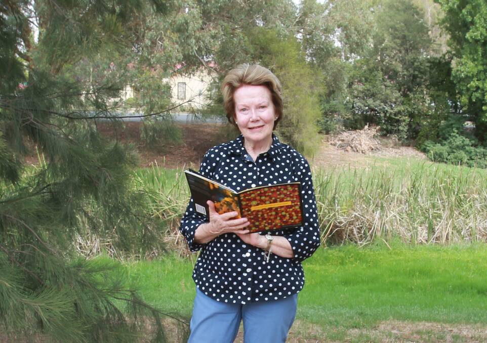 Margaret Cossey with a copy of "Words from the Heart - life, love and laughter", a profile of successful role models of Aboriginal and Torres Strait Islander people who've found success in many walks of life. 