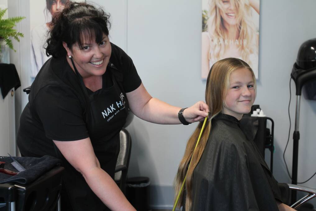 Juleann Tanks measures Andie McTavish's hair, being cut for the first time in her life to make wigs for children who lose their hair from cancer treatment.