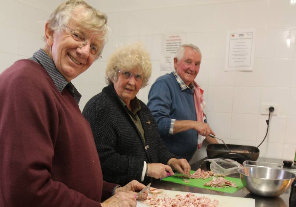 Volunteers: Terry and Elizabeth Charlton and Jim Slattery preparing ingredients for last Wednesday night's meal of curried sausages at the Cootamundra Community Kitchen.