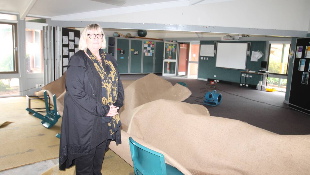 E A Southee Principal Leonie Stevenson in the damaged classrooms. Carpets have been rolled back but driers have been unable to dry them out adequately and the rooms have a strong musty smell.